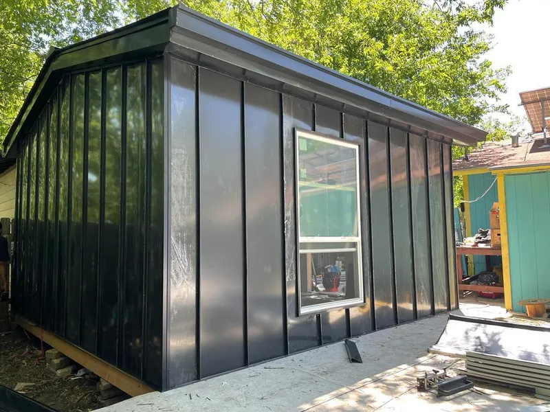 Black standing seam metal wall panels for Roof Inspection in North Star