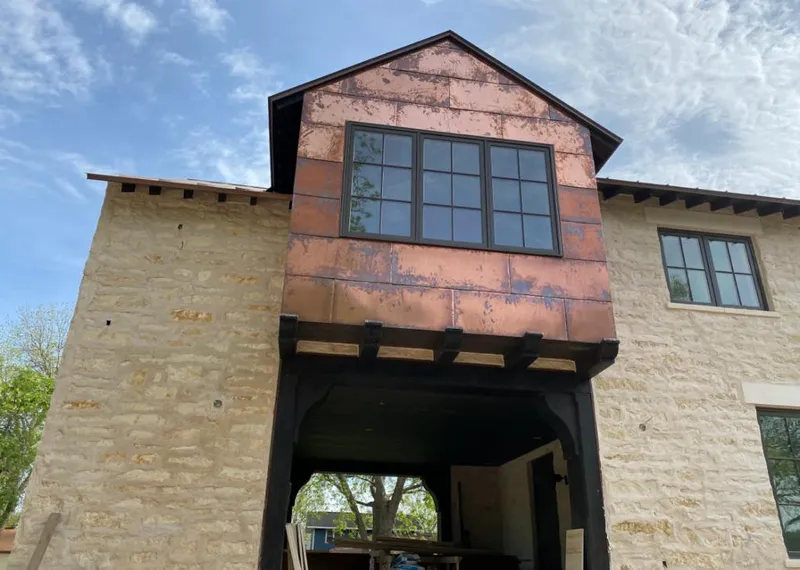 Copper metal panel facade on a stone building for Metal Roof Coating in North Star